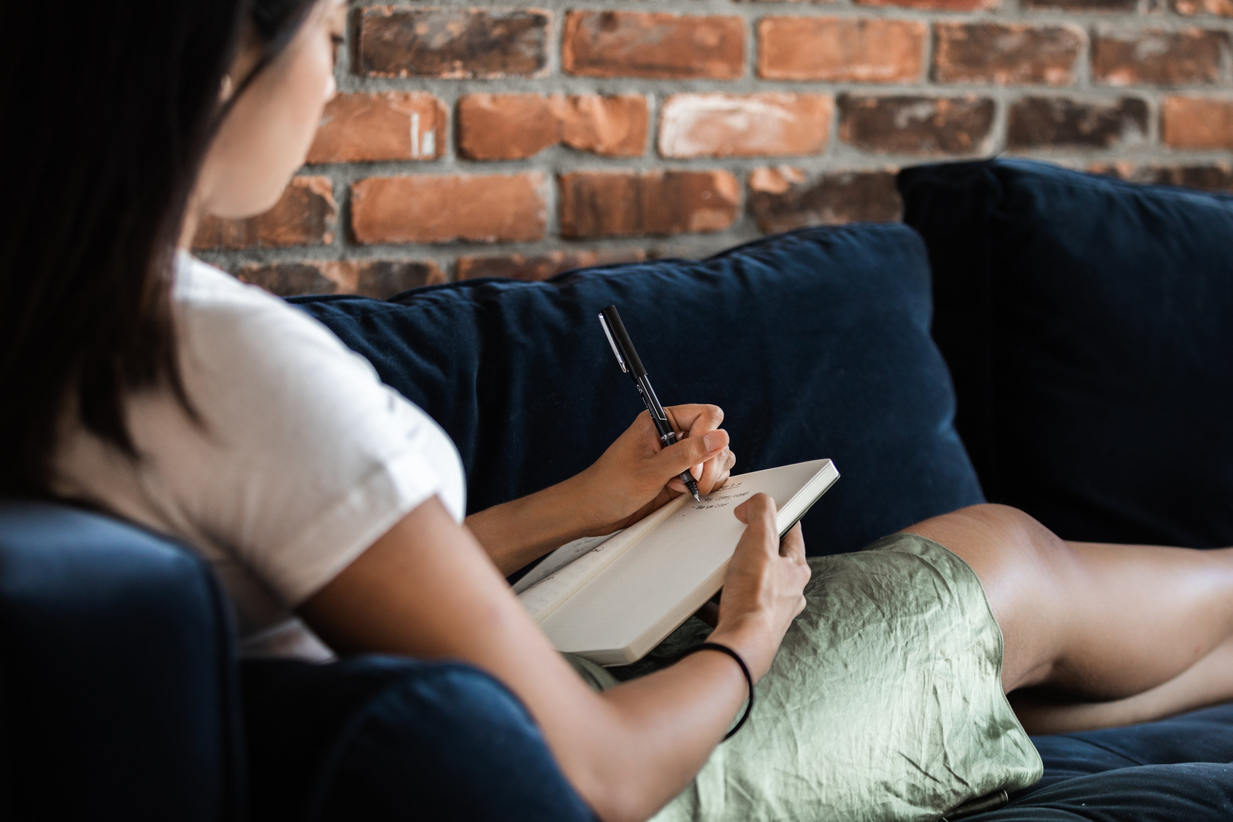 woman-relazing-and-journalling-on-couch.jpg